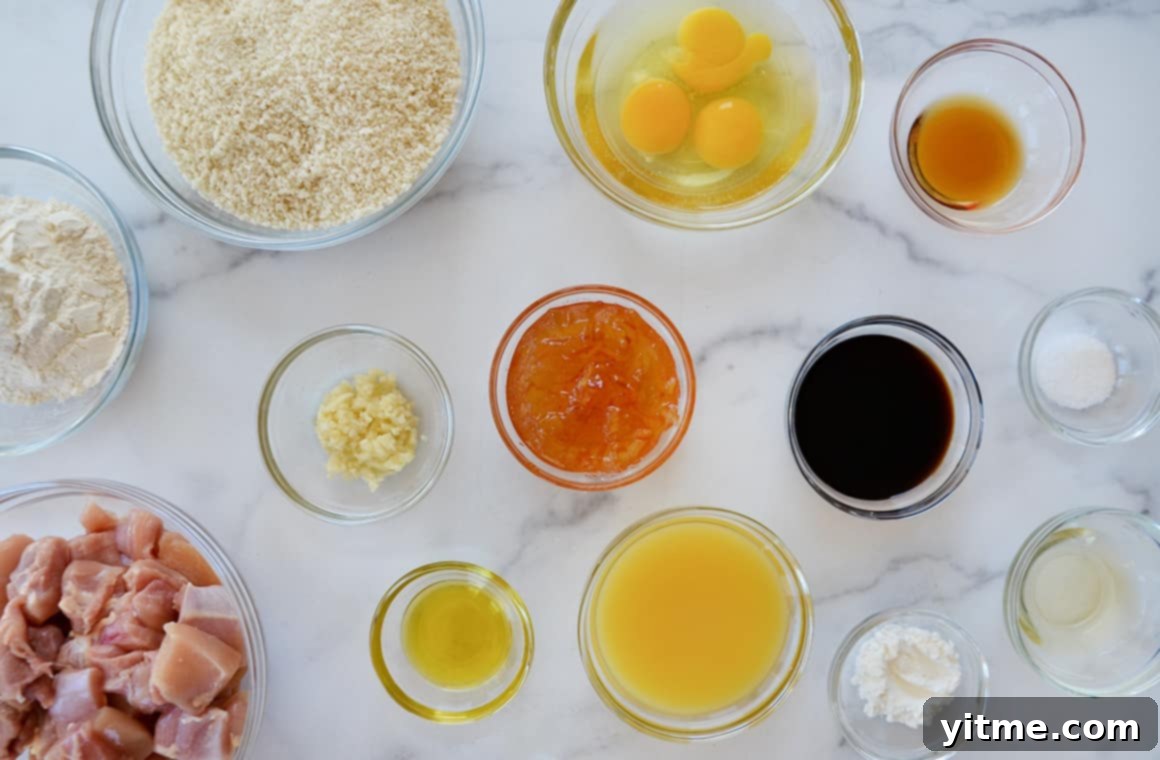 Crispy Citrus Chicken Bites 3 Glass bowls containing ingredients, including chicken thighs, orange juice and soy sauce