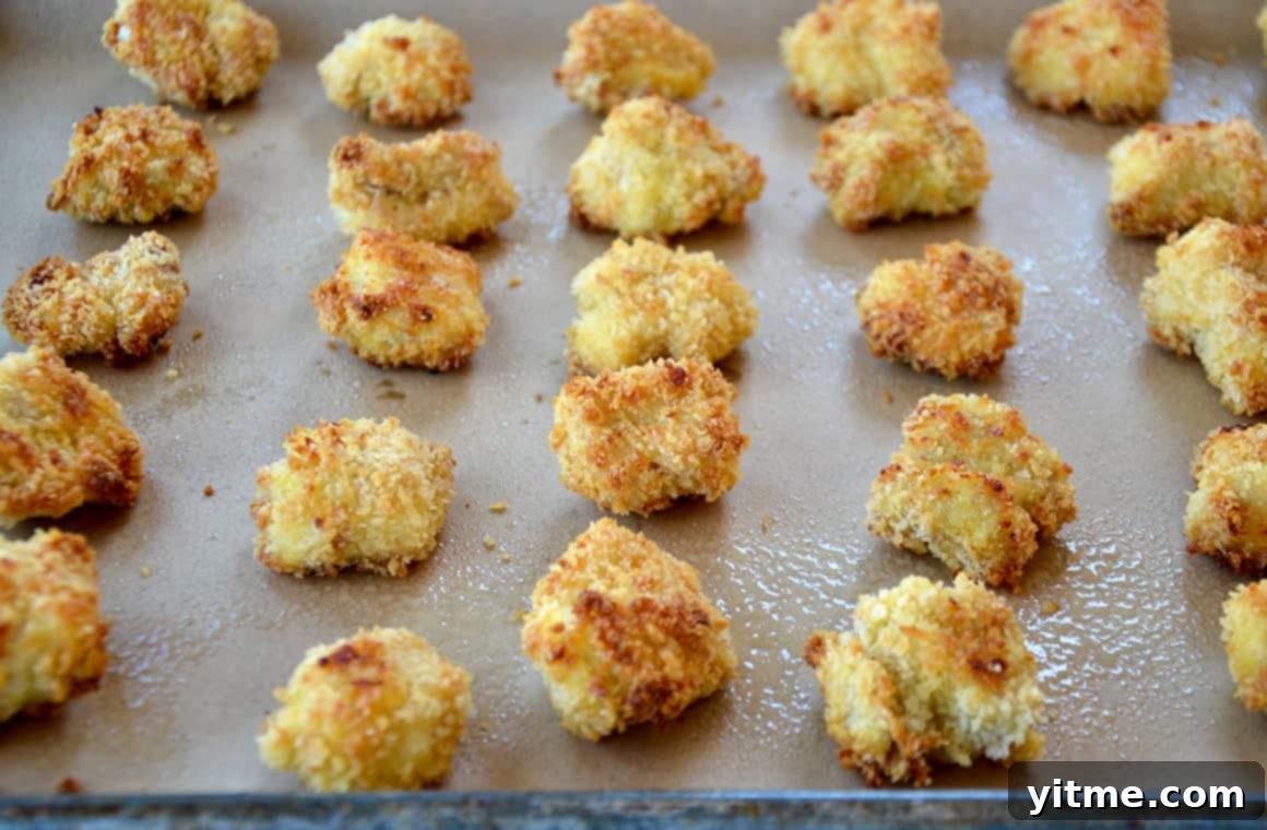 Crispy Citrus Chicken Bites 4 Homemade Panko chicken nuggets lined up on a baking sheet