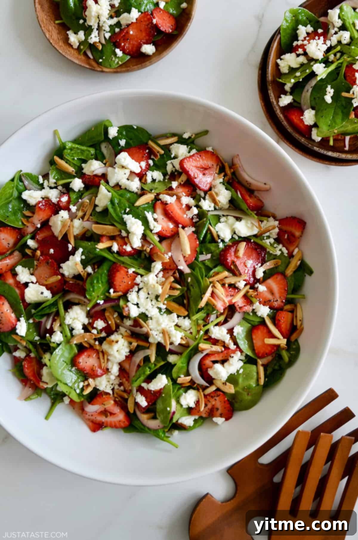 Spinach Strawberry Salad with Poppy Seed Dressing in a white serving bowl