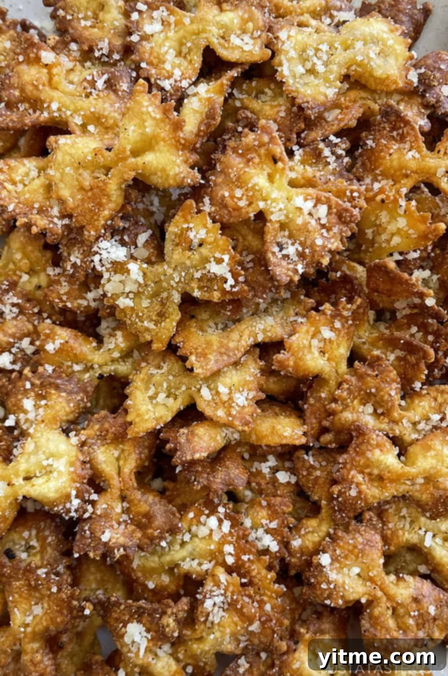 A close-up view of golden-brown Parmesan pasta chips, showcasing their texture