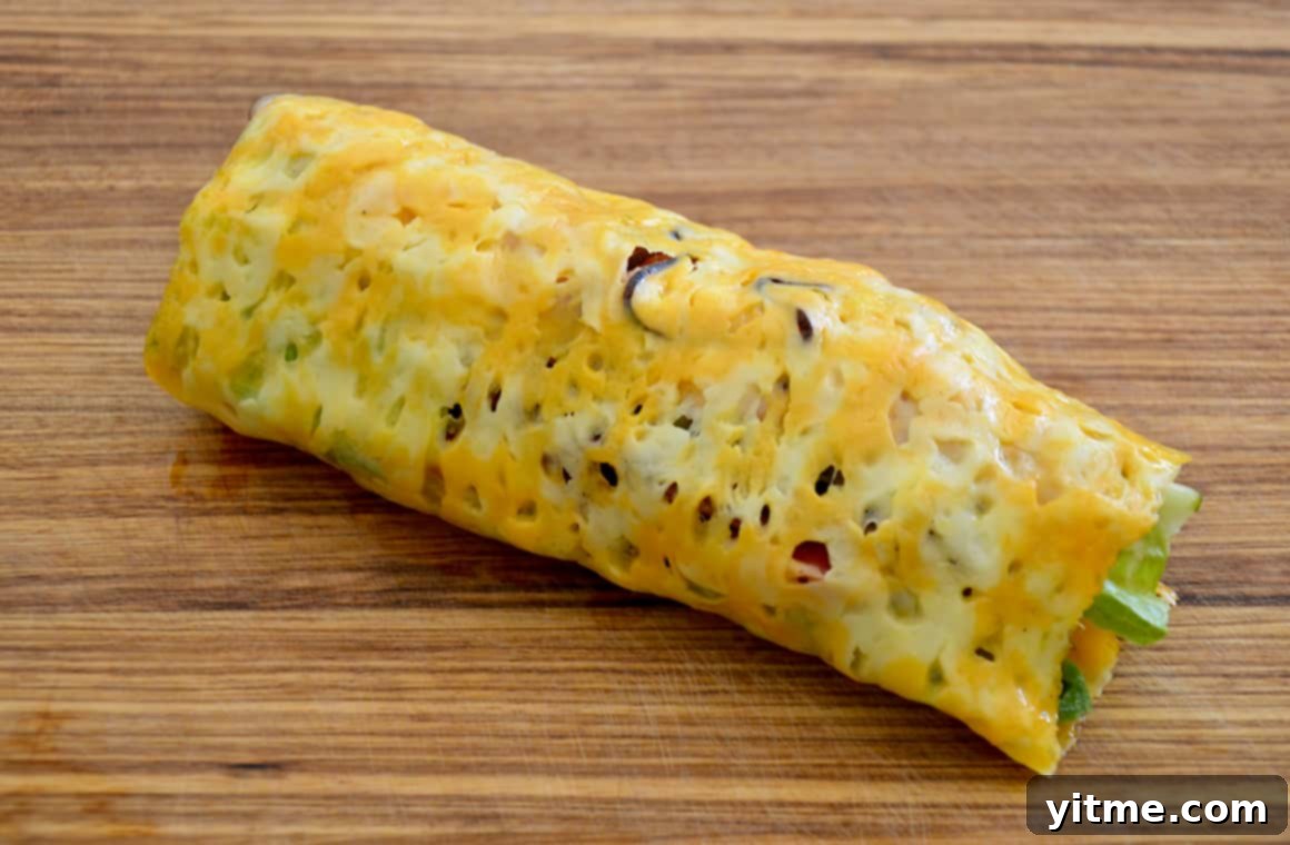 Cheesy Keto Wraps 6 Melted cheese sandwich wrap on a wood cutting board