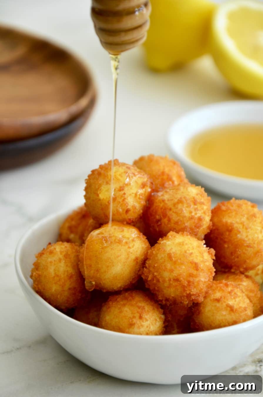 Close up of crispy fried goat cheese balls.
