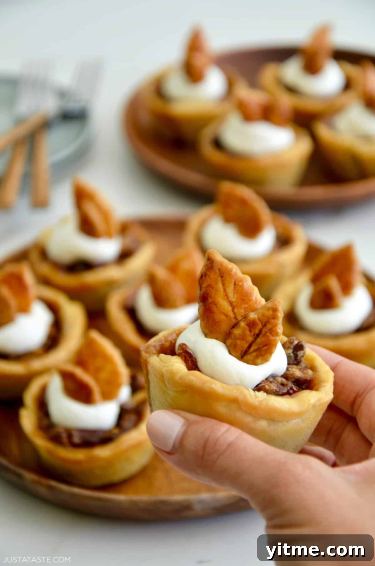 Mini pecan pie held in hand