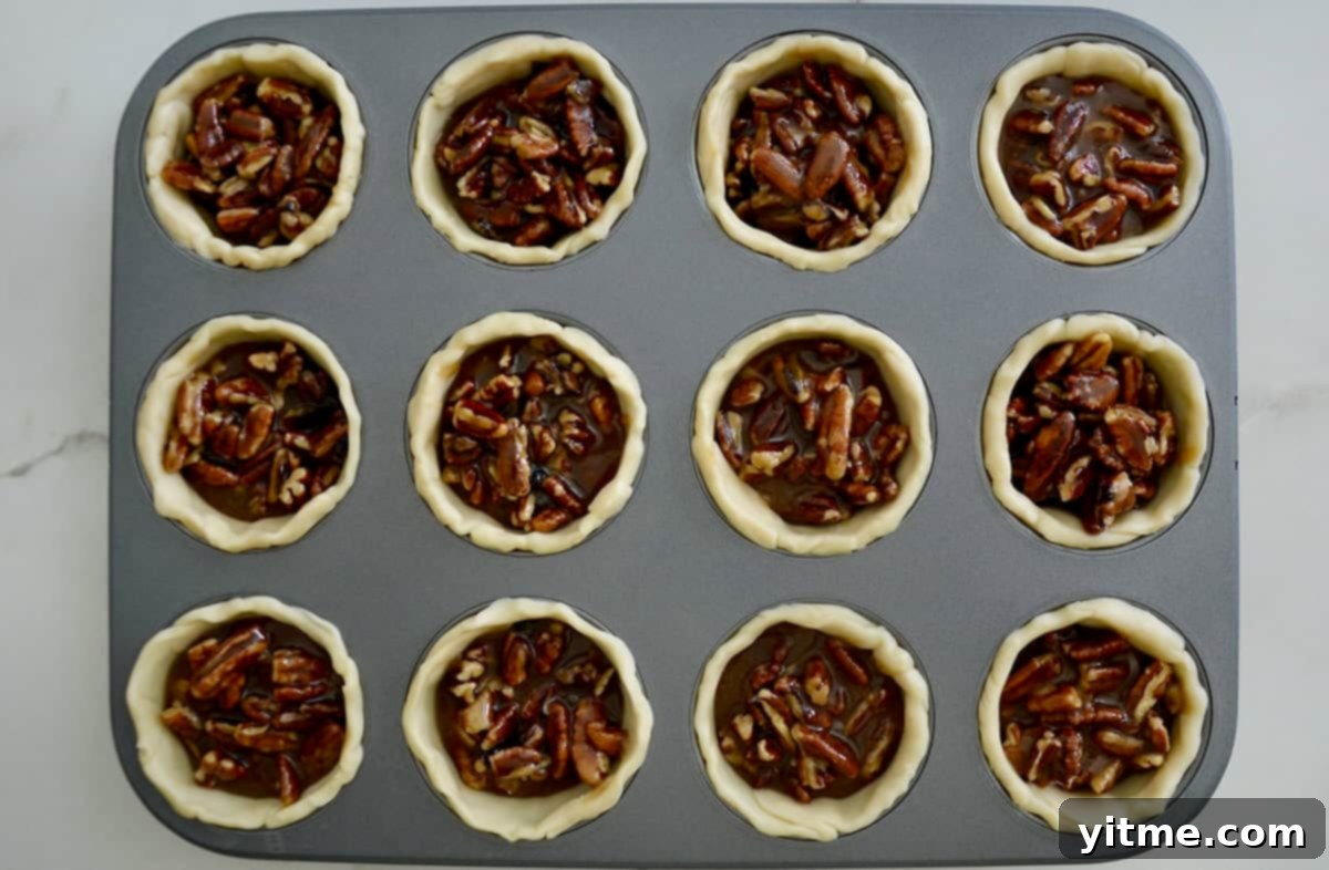 Mini pecan pies in a muffin tin
