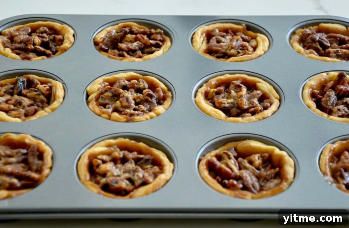 Baked mini pecan pies in a muffin tin