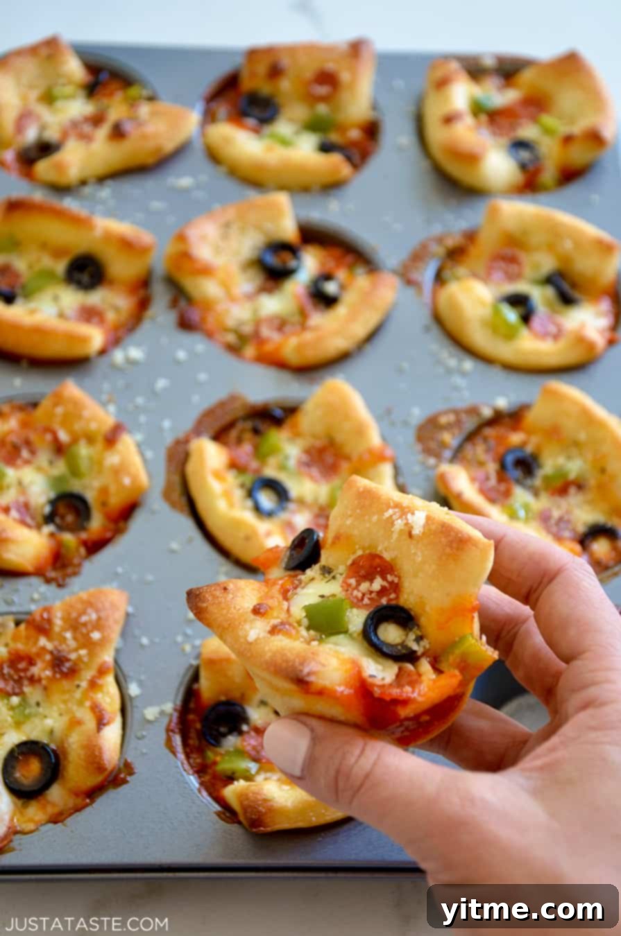 Muffin Tin Pizzas: Bite-Sized Fun 3 Hand holding an Easy Cheesy Pizza Cup