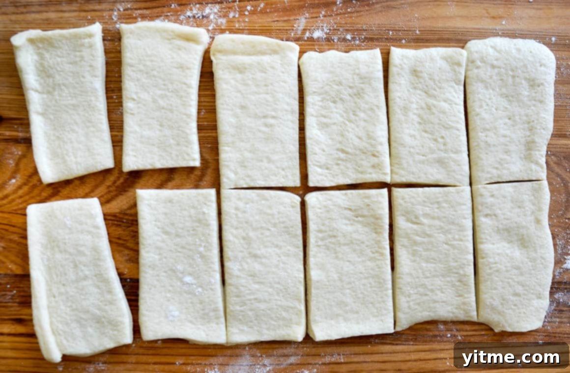 Muffin Tin Pizzas: Bite-Sized Fun 4 Sliced pizza dough on a wooden surface