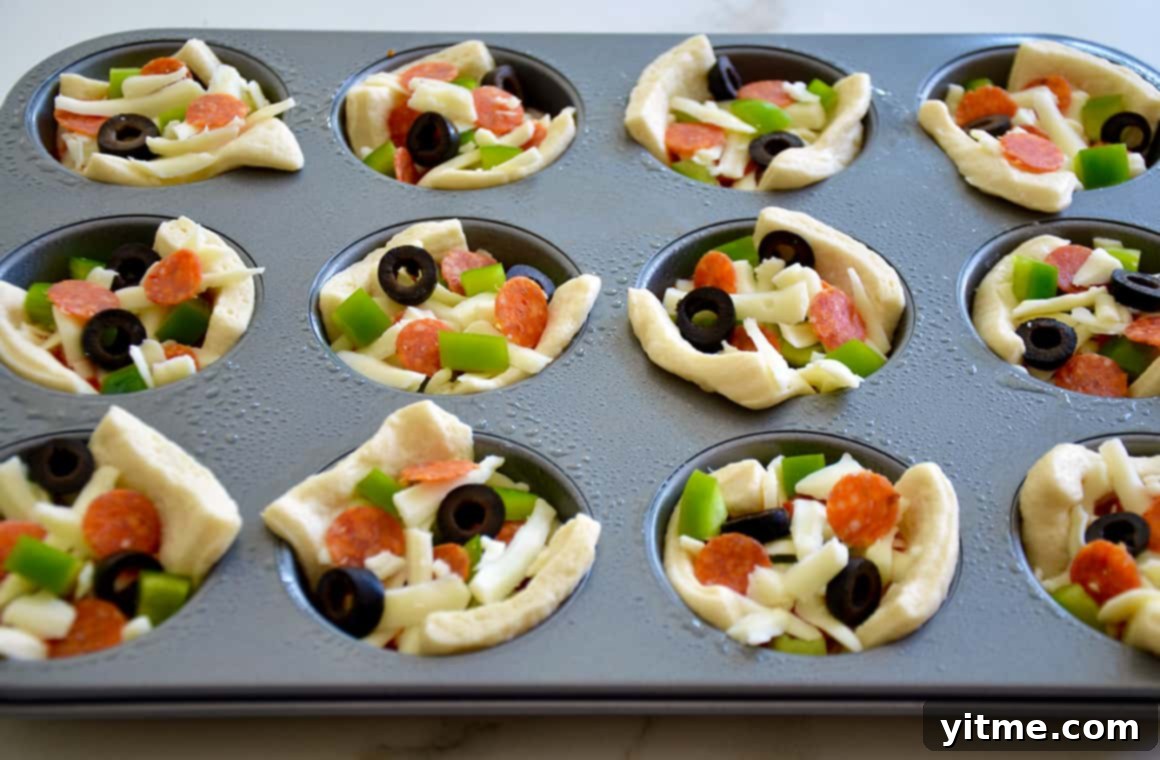 Muffin Tin Pizzas: Bite-Sized Fun 6 Individual pizzas in a muffin tin