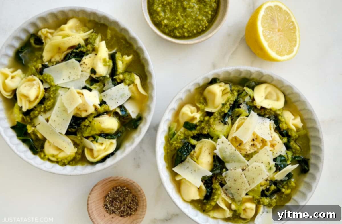 Tortellini Soup with Tuscan Kale 7 Two bowls of tortellini soup topped with Parmesan and pesto.