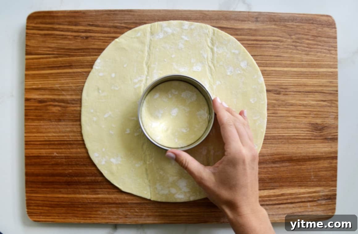 Using a cookie cutter on puff pastry for the wreath's center