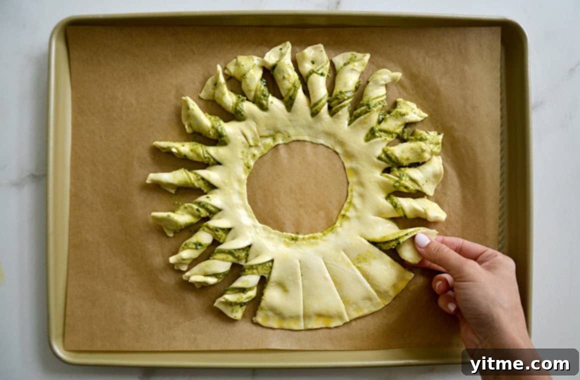 Twisting each strip of puff pastry