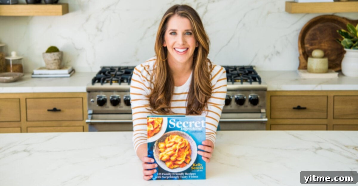 Top Recipes That Defined 2021 3 Kelly Senyei holding a copy of The Secret Ingredient Cookbook