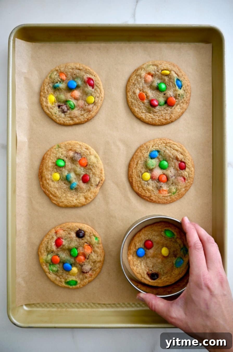 M&M's Soft Cookie Delights 6 Using a circular cookie cutter over a hot cookie