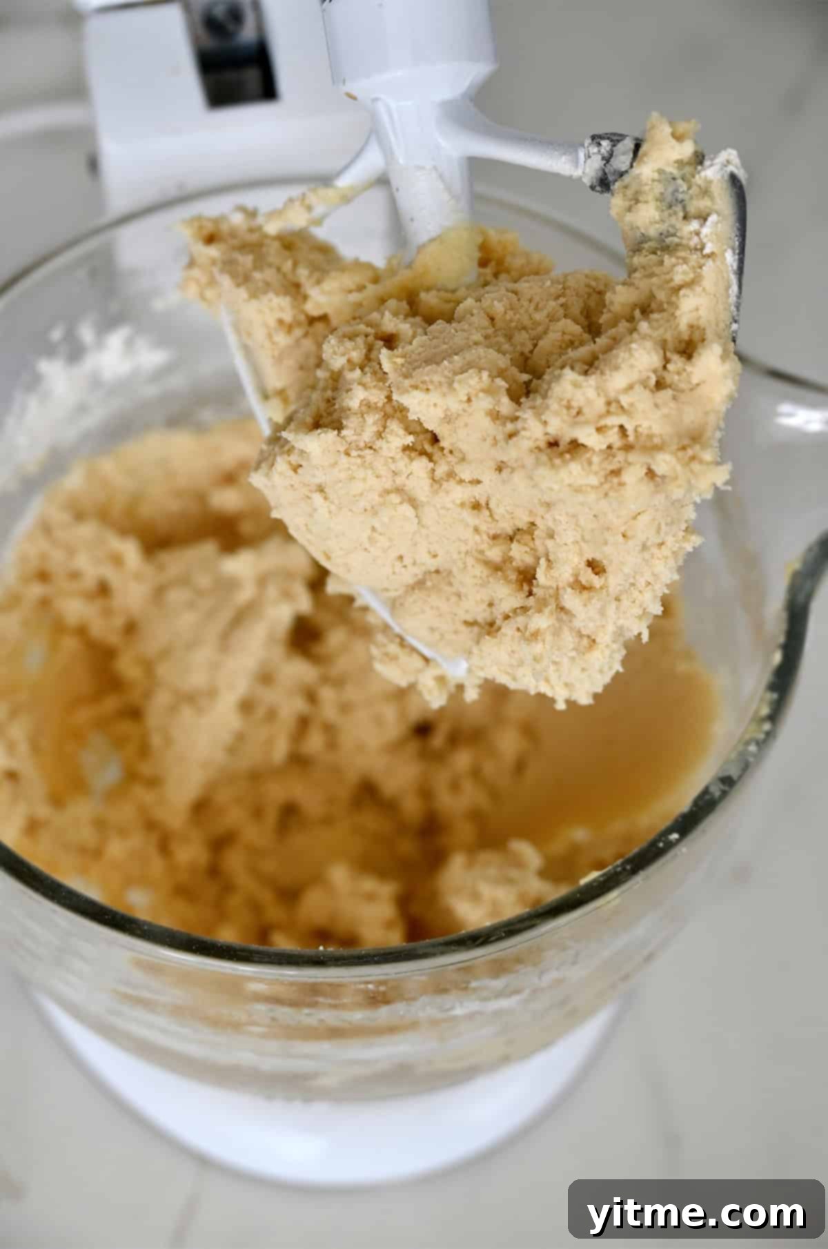 Sugar cookie dough ingredients in a stand mixer bowl.