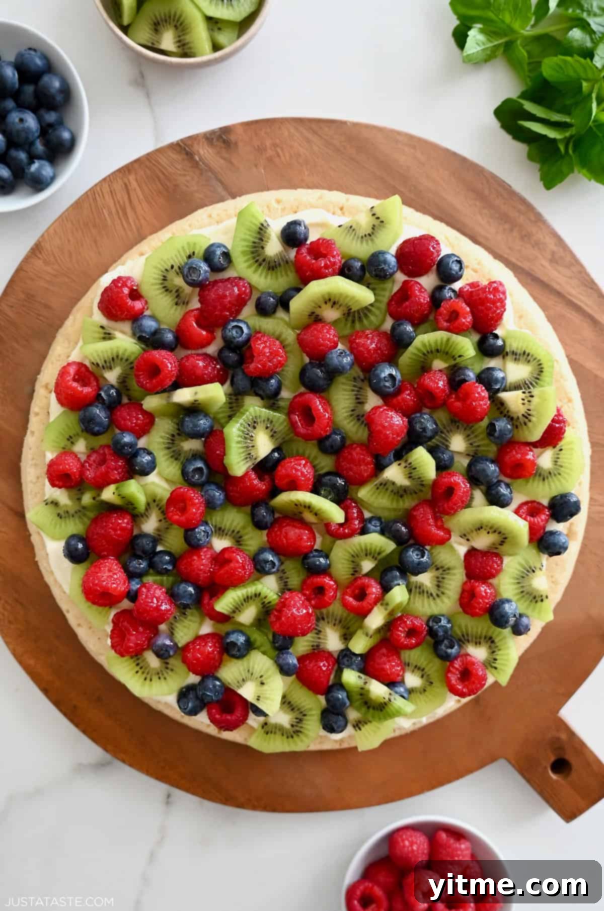 Sugar cookie fruit pizza on a round platter.