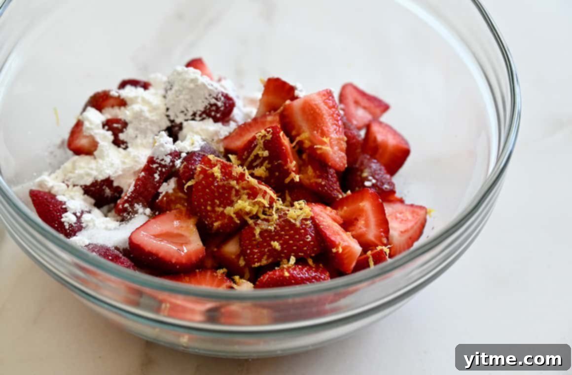 Puff Pastry Galette: A Simple Guide 4 Sliced strawberries, lemon zest, sugar, and cornstarch in a bowl