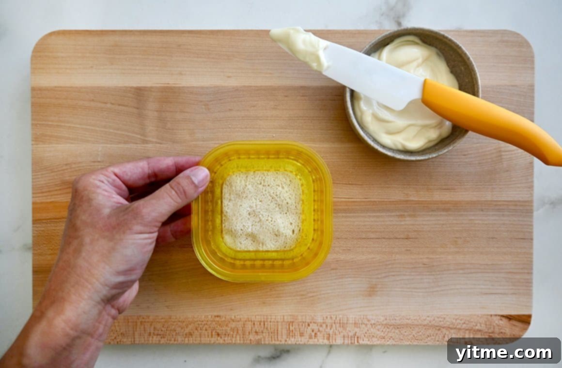Air Fryer Grilled Cheese Perfection 4 A grilled cheese Uncrustable sandwich on a wood cutting board.