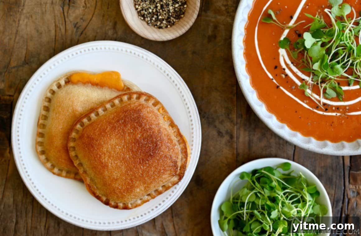 Air Fryer Grilled Cheese Perfection 5 Air fryer grilled cheese sandwiches on a plate with tomato soup.