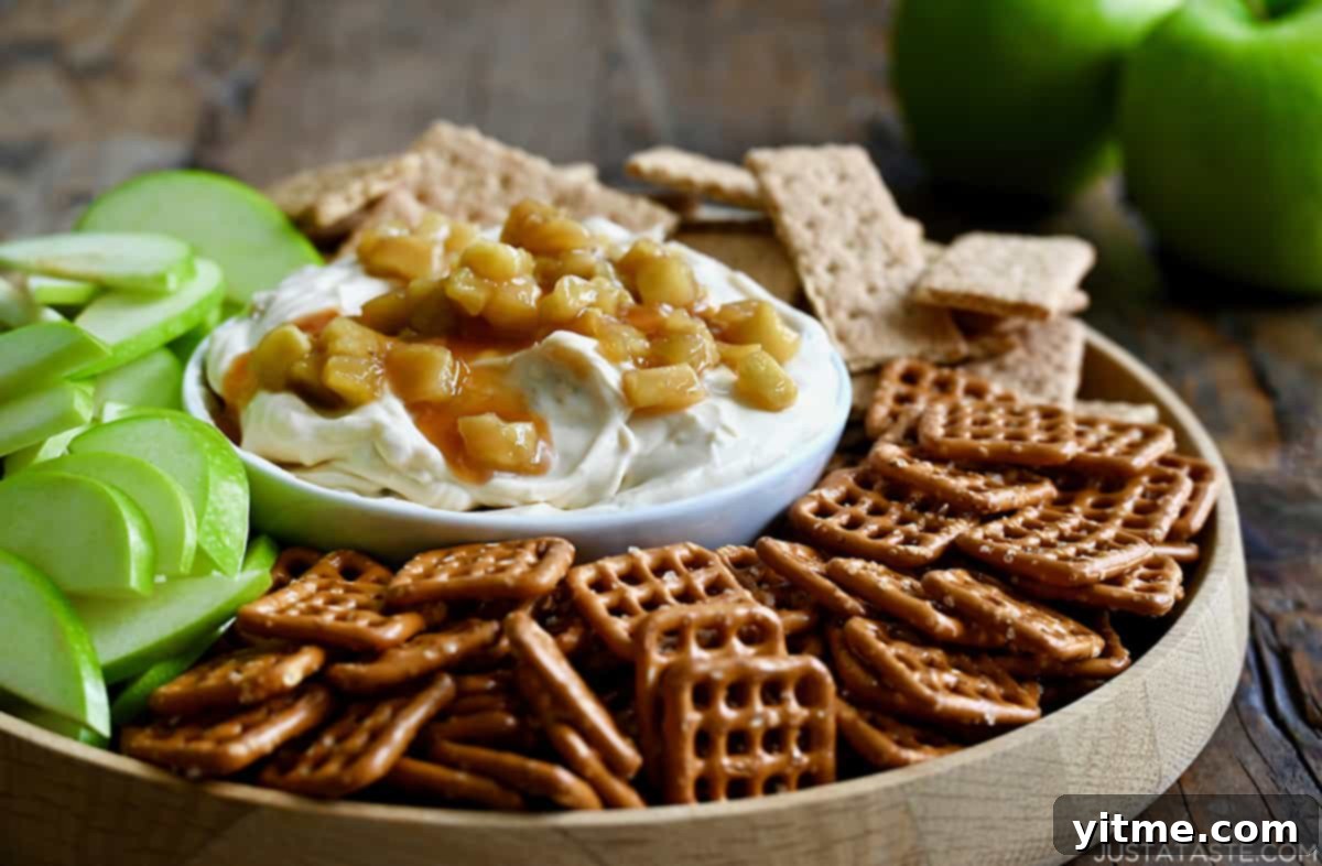 Caramel Apple Dessert Dip 5 Caramel Apple Cheesecake Dip served with pretzels, apples, and graham crackers.