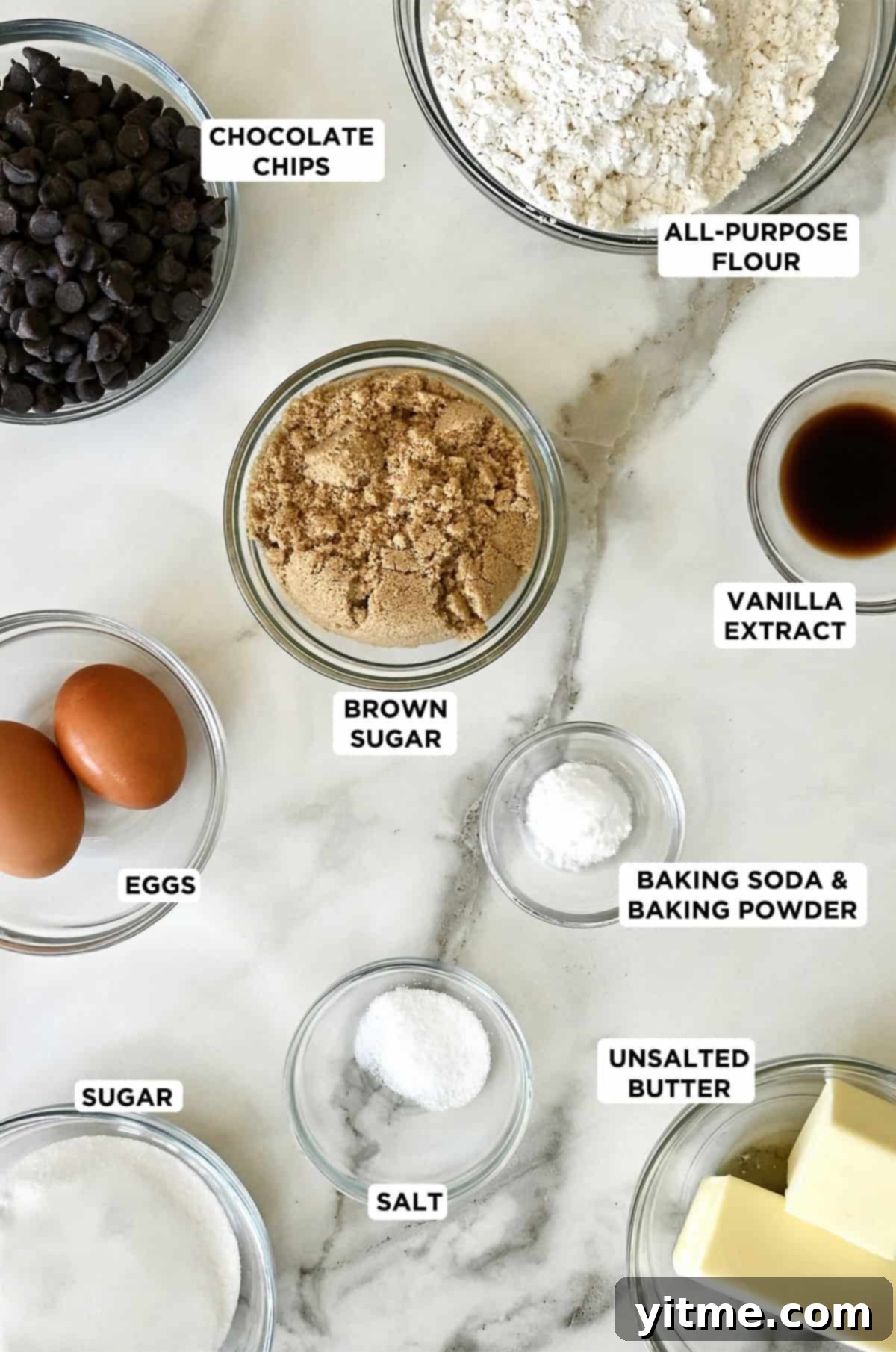 A selection of chocolate chip cookie ingredients in glass bowls.