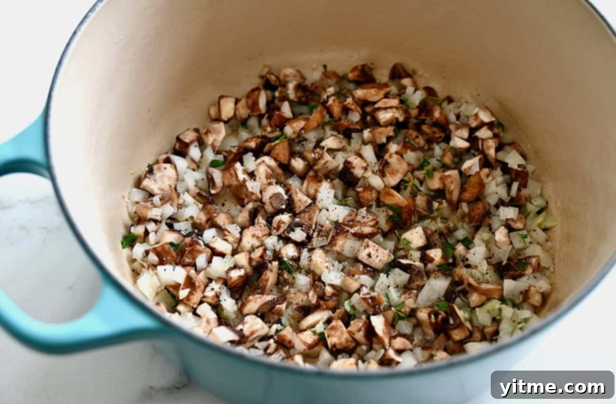 Effortless Turkey Tetrazzini 3 A large stockpot containing sautéed mushrooms, onions, and herbs, forming the flavorful base for the turkey tetrazzini sauce.