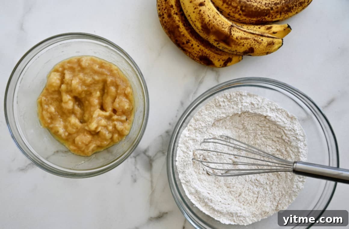 Speedy Banana Fritters 3 A bunch of ripe bananas next to a bowl containing flour and a bowl containing mashed bananas, ready for mixing.