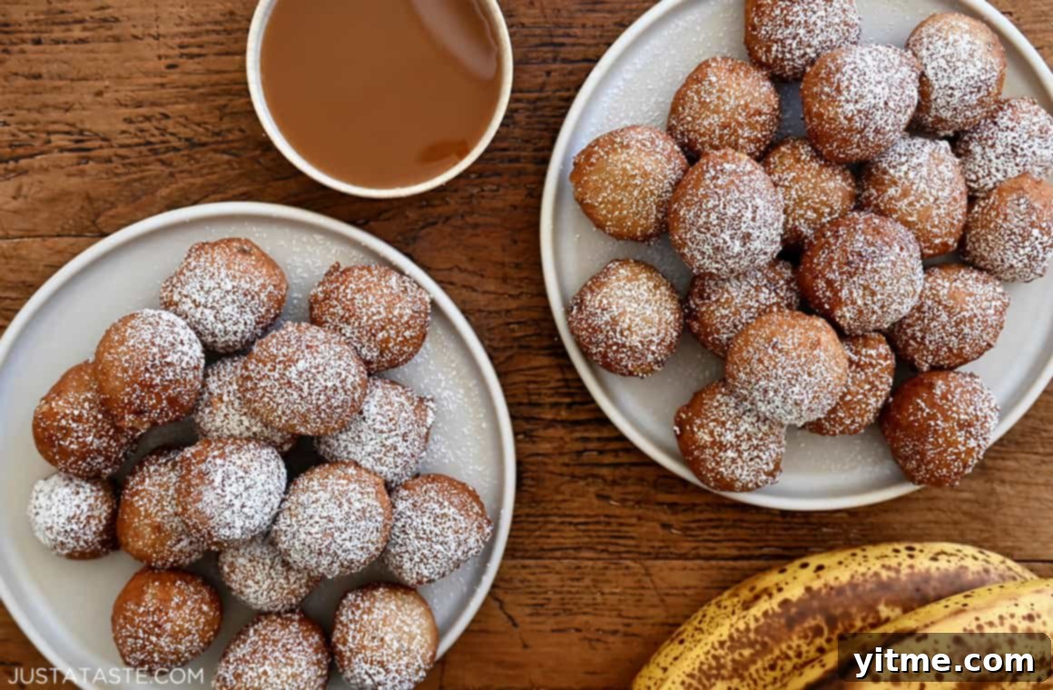 Speedy Banana Fritters 7 Two plates piled high with easy banana fritters dusted with powdered sugar, served alongside a small bowl filled with rich caramel sauce.