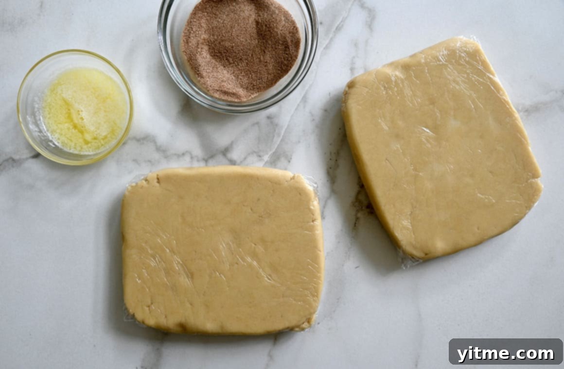 Cinnamon Swirl Cookies 4 Chilled dough squares wrapped in plastic wrap next to bowls of melted butter and cinnamon-sugar mixture