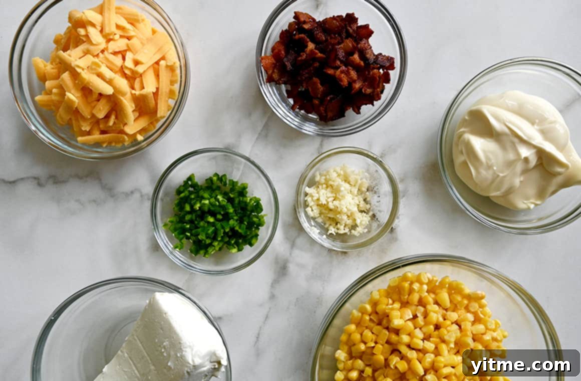 A top-down view of bowls filled with fresh ingredients for Jalapeño Corn Dip including shredded cheddar cheese, crispy bacon pieces, creamy mayonnaise, vibrant corn kernels, minced garlic, chopped jalapeño, and a block of cream cheese