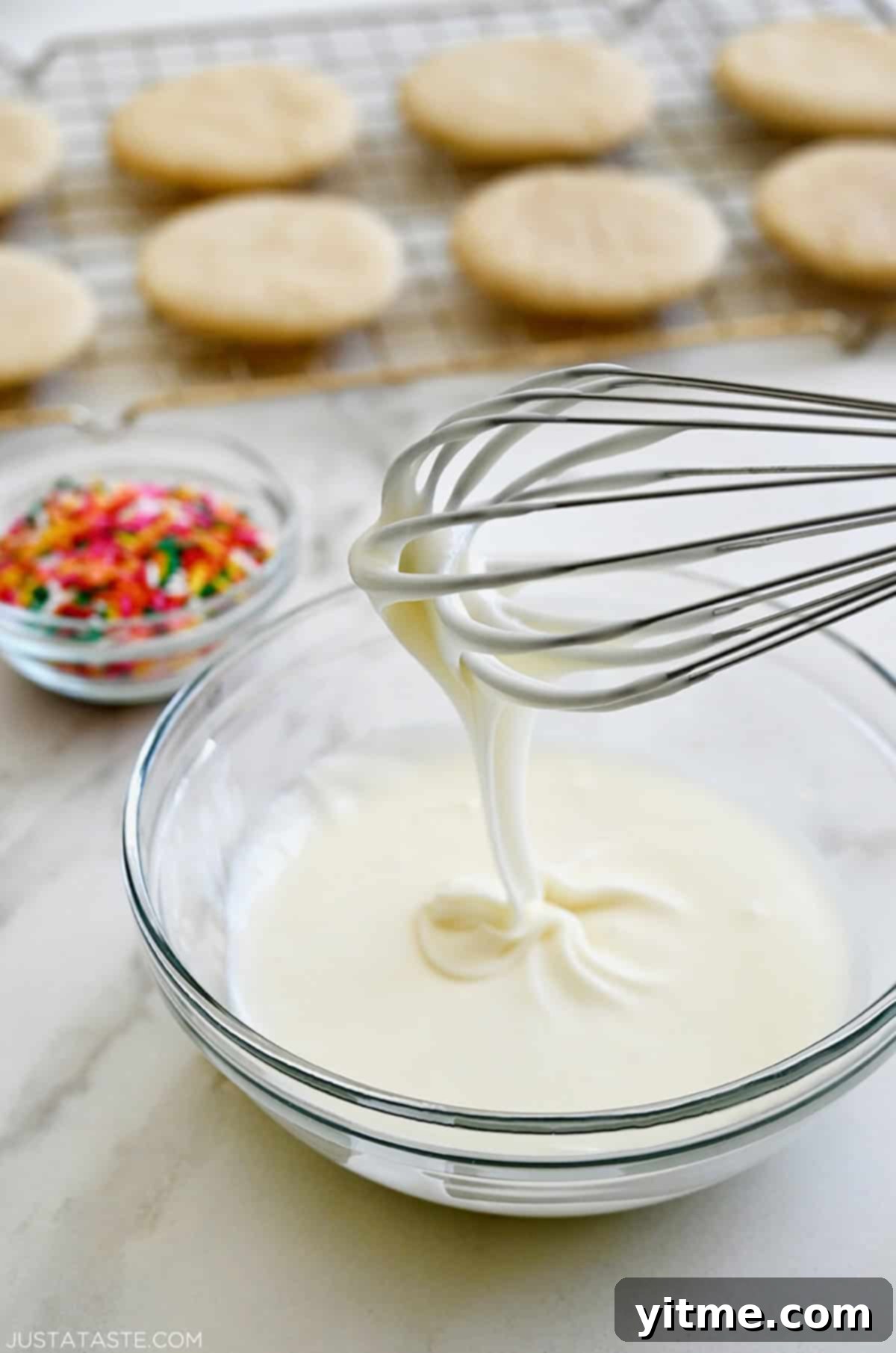 Silky Smooth Sugar Cookie Icing 3 Whisking together the three simple ingredients – confectioners' sugar, melted butter, and whole milk – to create smooth sugar cookie icing.