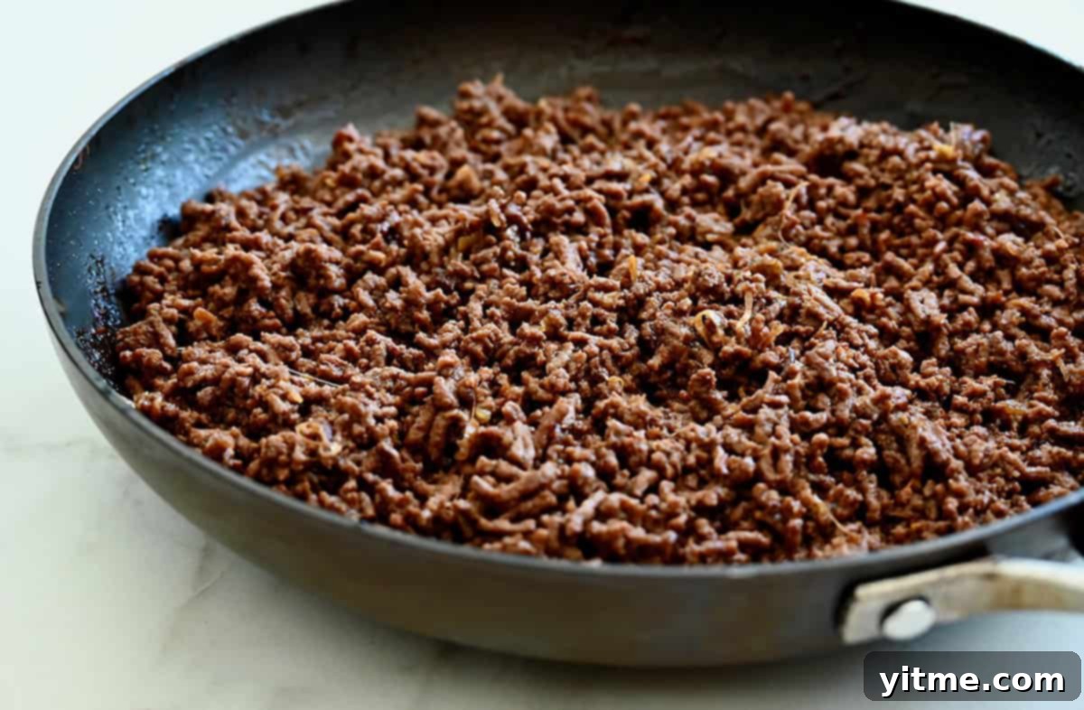 Browned Korean ground beef in a skillet.