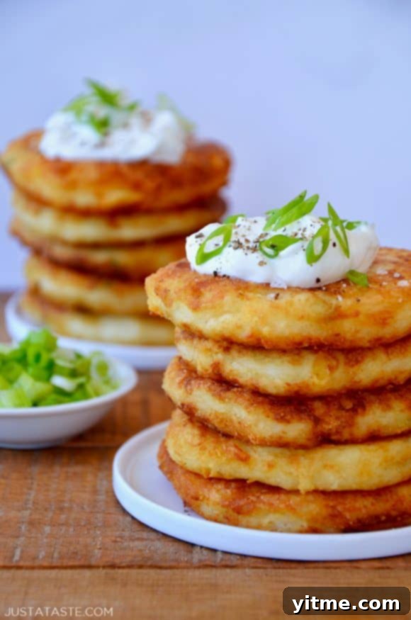 Top Trending Recipes of 2022 4 Stacks of mashed potato pancakes topped with sour cream and scallions