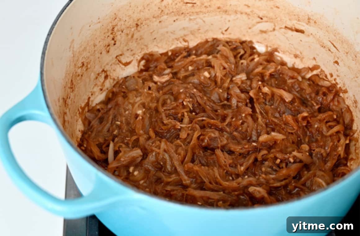 Sweet and savory caramelized onions simmering in a pot.