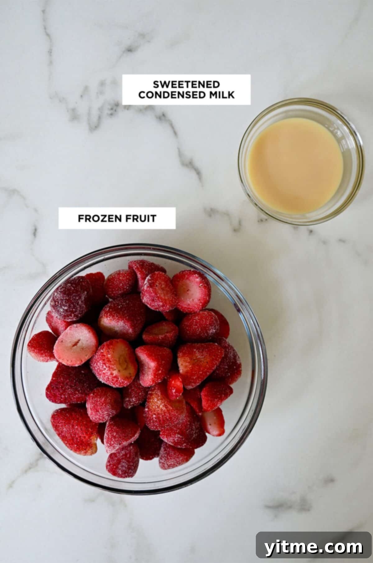 Ingredients for shaved ice in glass bowls: frozen strawberries and sweetened condensed milk