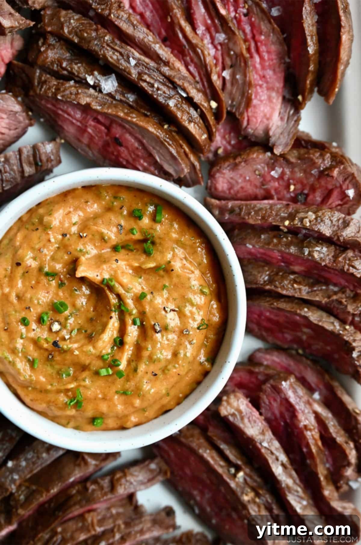 Cowboy Spice Infusion Butter 5 Cowboy butter served with sliced flank steak.