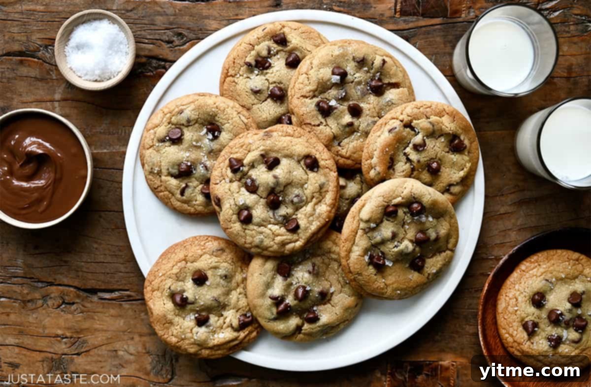 Nutella chocolate chip cookies served on a round platter with glasses of milk.