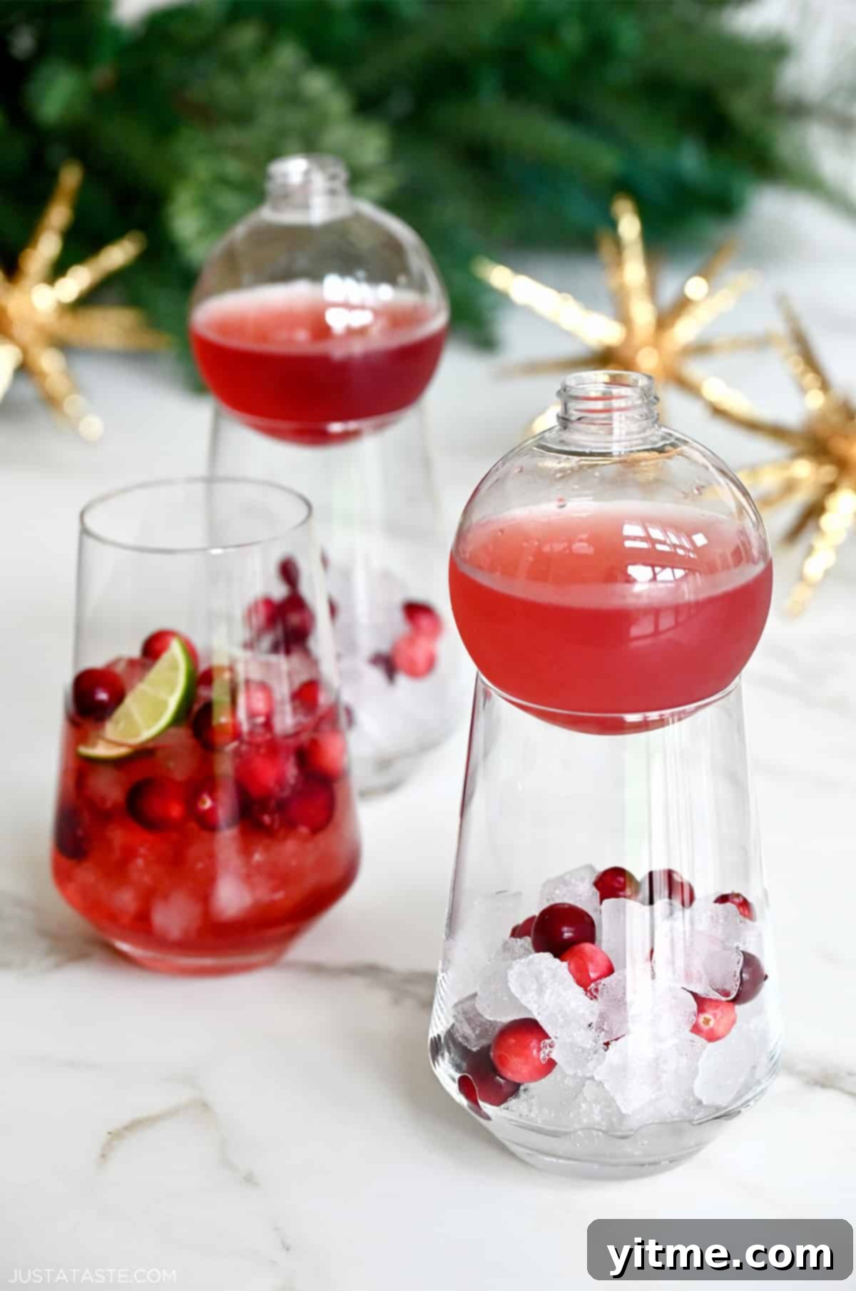 Christmas Margarita in cocktail glasses with cranberries