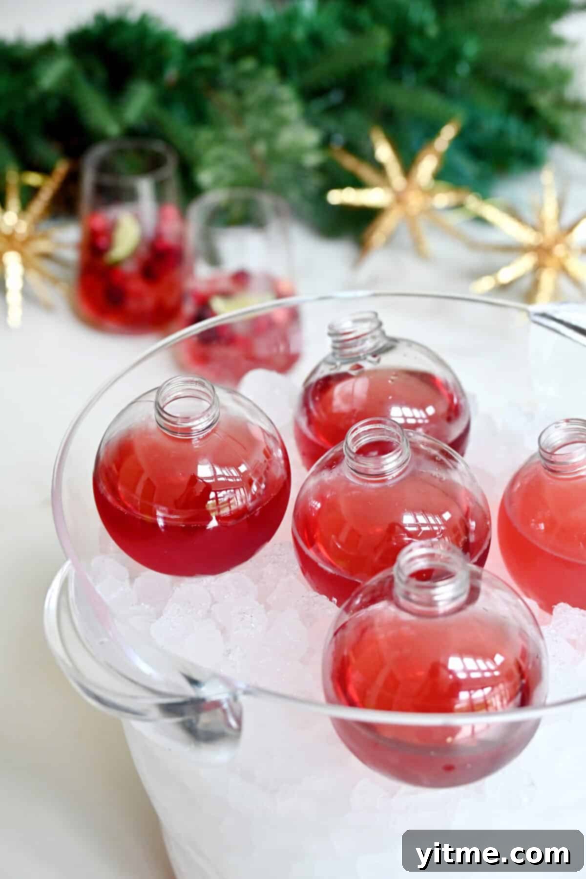 Christmas Margaritas in ornament balls in an ice bucket