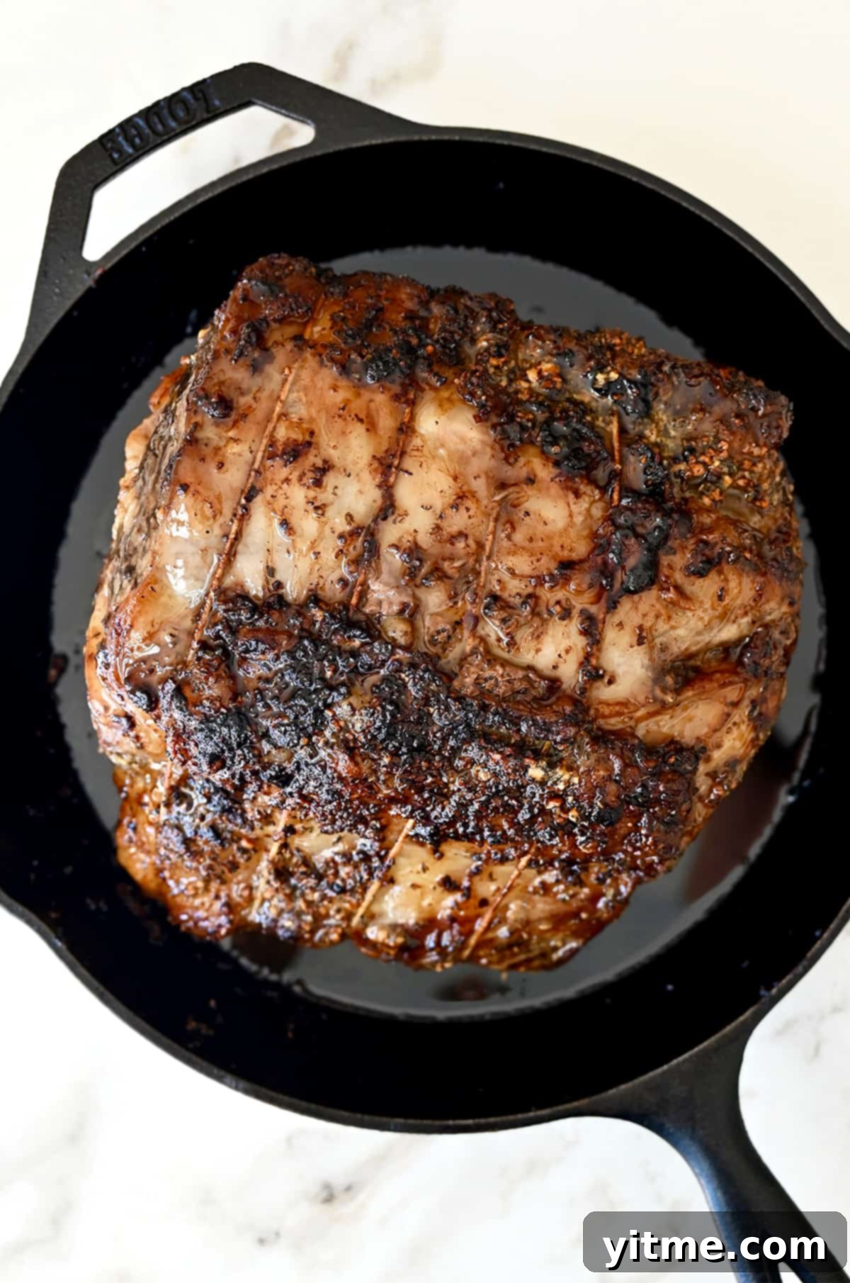 Roasted prime rib in a cast-iron skillet.