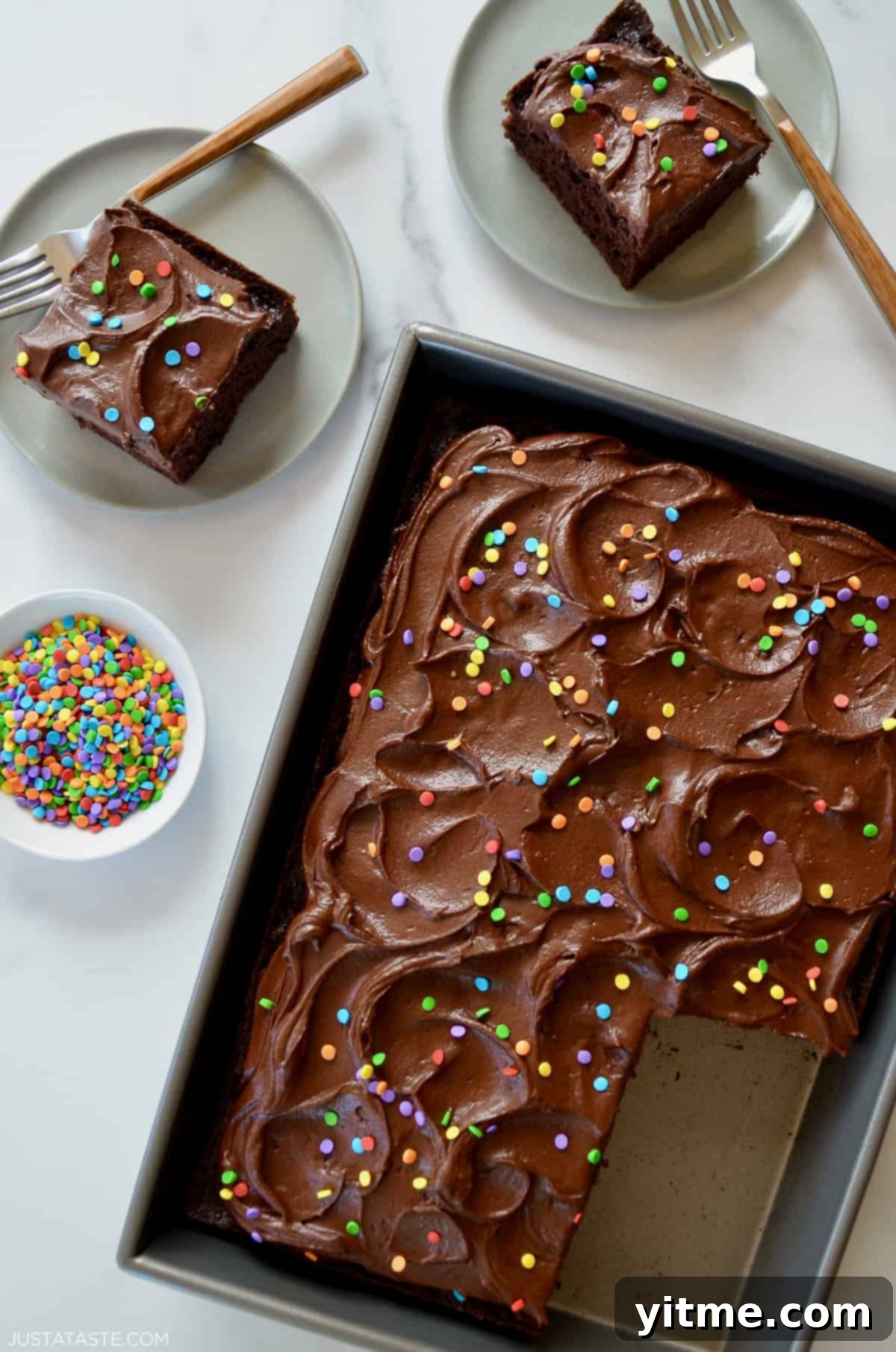 A decadent chocolate sheet cake generously covered in rich, silky 5-Minute Chocolate Buttercream Frosting and adorned with festive rainbow sprinkles.