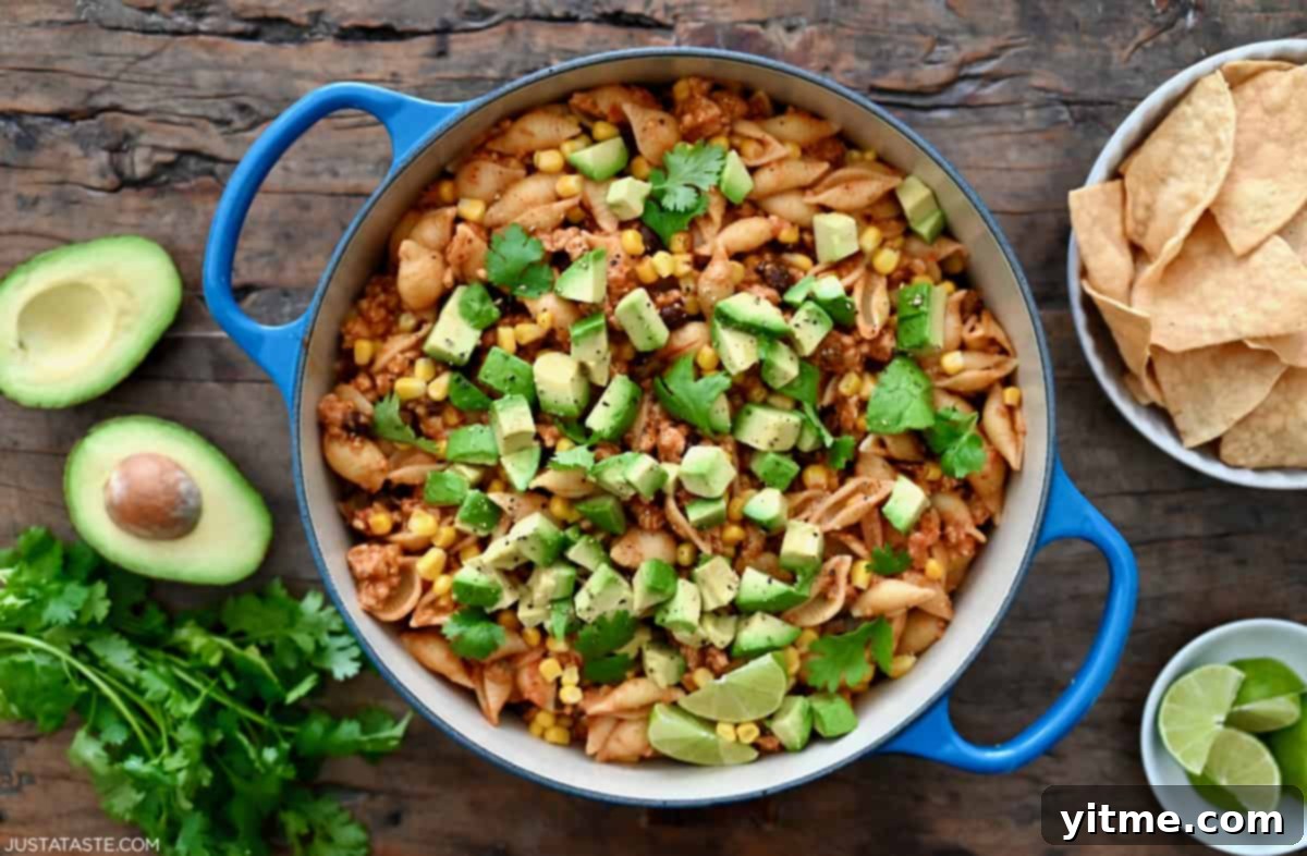 Cheesy Taco Pasta Shells with avocado and cilantro