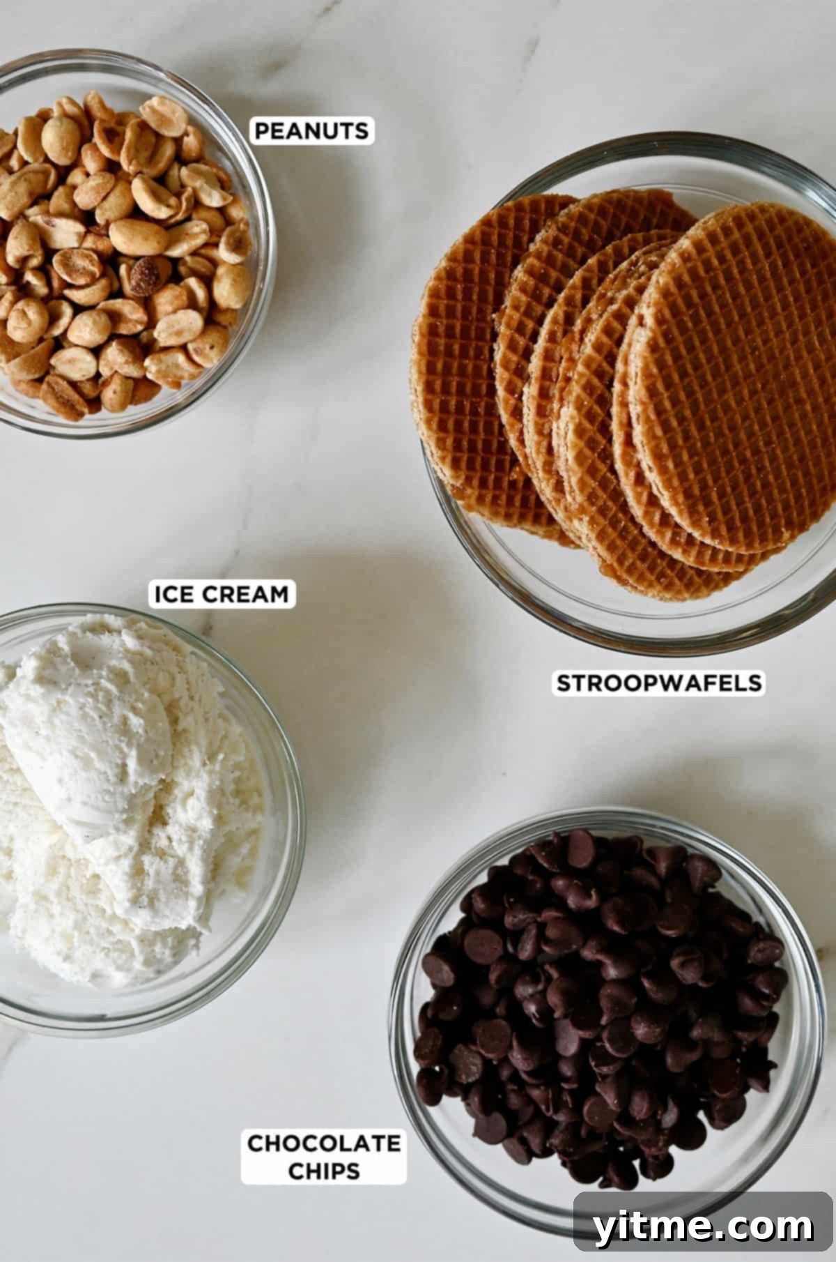 Ingredients for homemade choco tacos: peanuts, stroopwafels, chocolate chips, and vanilla ice cream