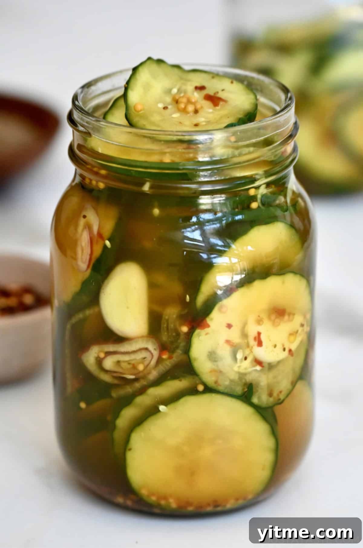 Homemade bread and butter pickles in a Mason jar.