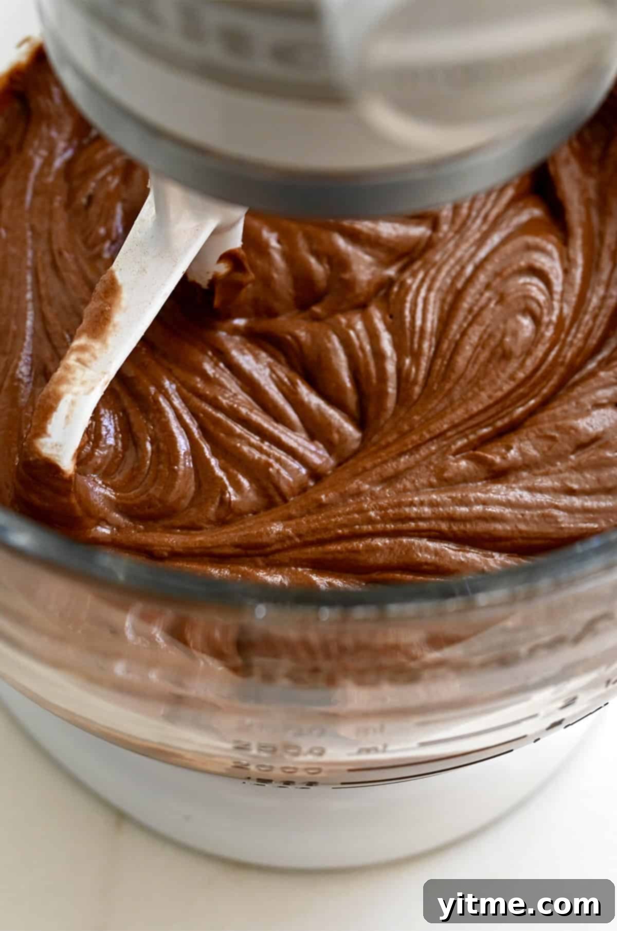 Chocolate cake batter in a stand mixer bowl with the paddle attachment.