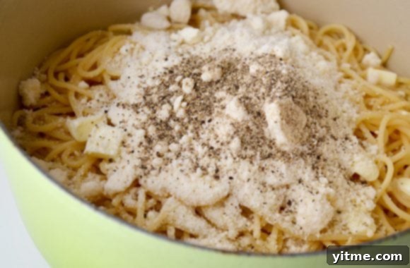 Cacio e Pepe: The Quintessential Roman Comfort Food 4 Cacio e Pepe pasta topped with freshly grated Parmesan cheese and black pepper