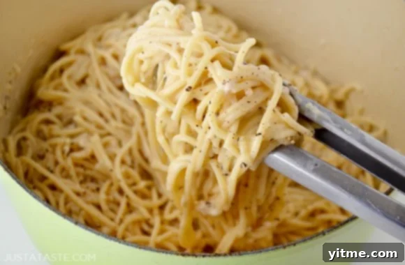Cacio e Pepe: The Quintessential Roman Comfort Food 5 Large pot of Cacio e Pepe pasta with tongs