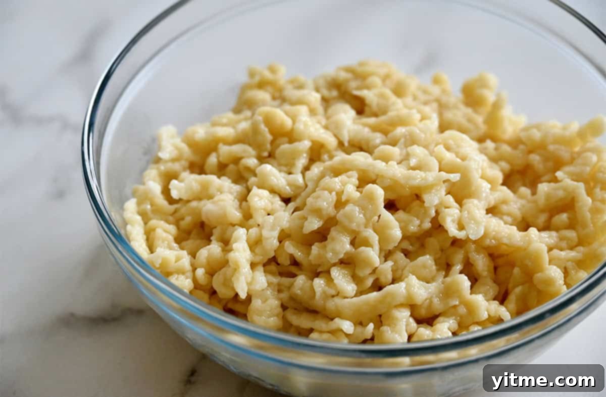 Cooked spaetzle in a glass bowl.