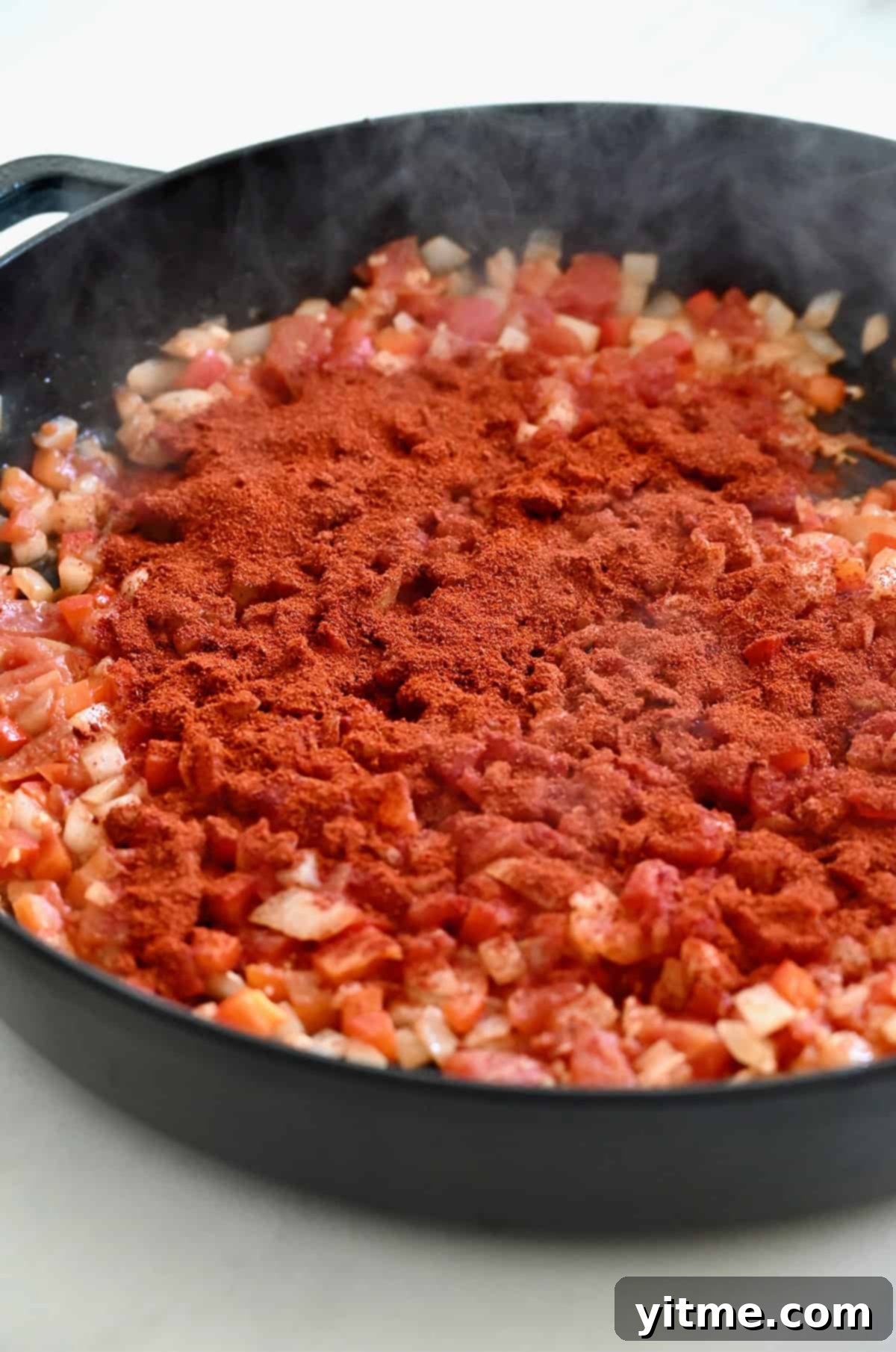 Hungarian paprika atop cooked diced veggies.