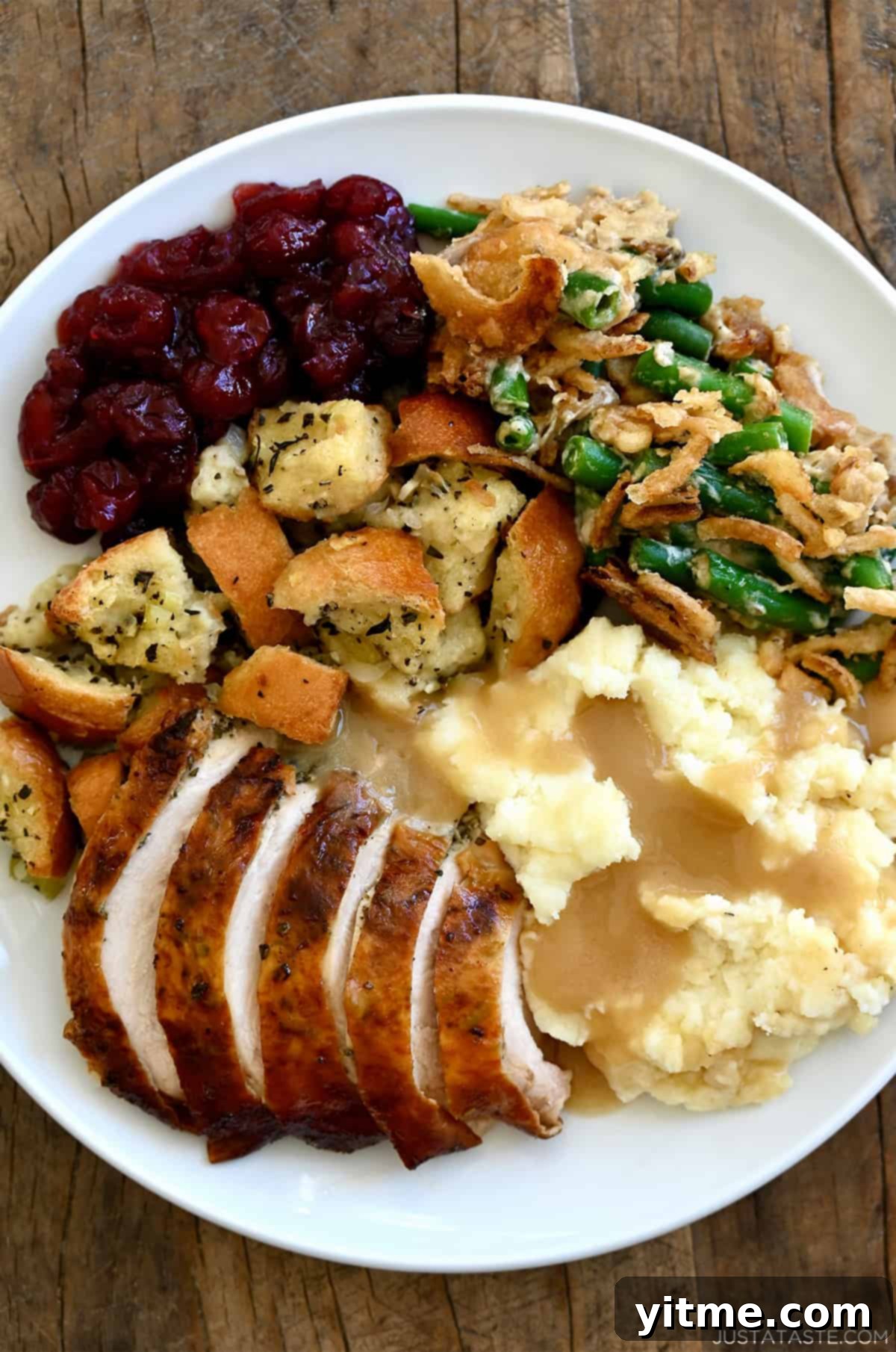 Thanksgiving turkey on a plate with traditional side dishes, creating a festive holiday meal.