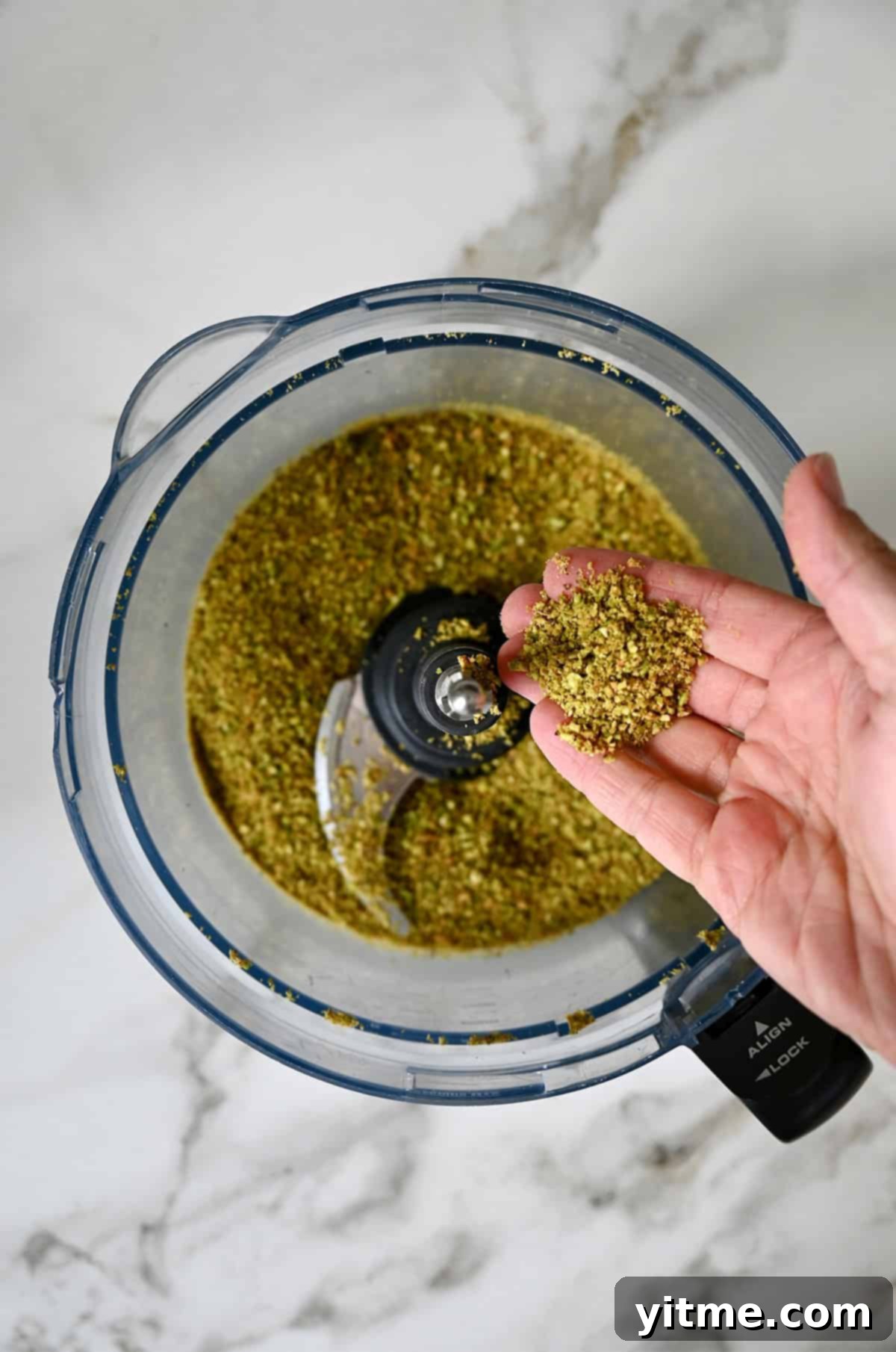 Finely ground pistachios in a food processor.